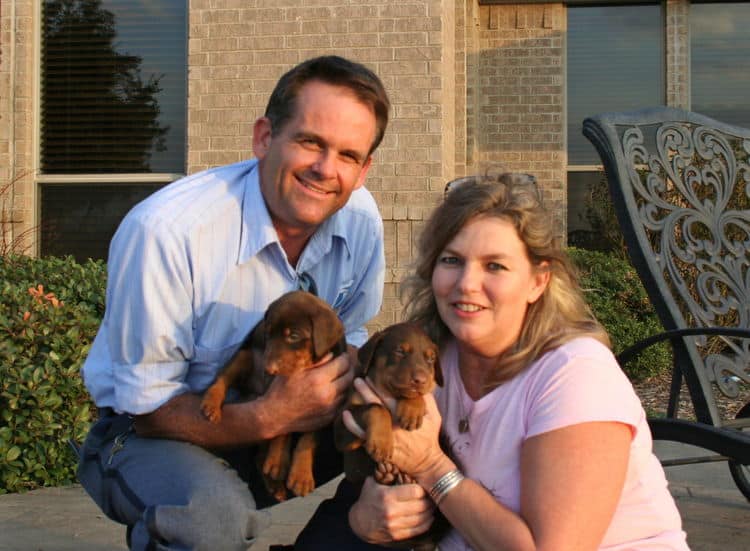 red male dobe pup with new owners